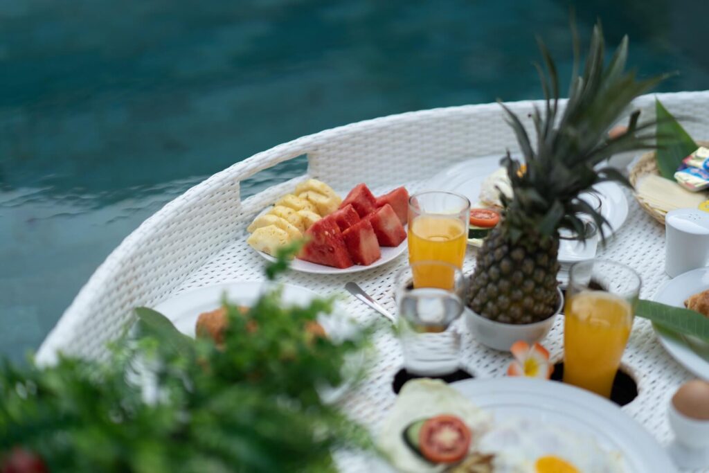 A floating breakfast set on the pool at a SANTAI STAYS villa in Bali